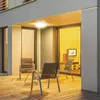An outdoor patio area with chairs and a table, illuminated by a ceiling light. Náhled obrázku produktu