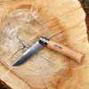 A pocket knife is placed on a wooden surface. Náhled obrázku produktu