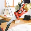 A person is using a Black & Decker electric saw to cut a piece of wood. Podgląd zdjęcia produktu