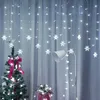 A decorated Christmas tree and a floor lamp with string lights in front of a curtain. Náhled obrázku produktu