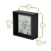 A black 3D deep box picture frame with a floral image inside, with dimensions indicated by green lines and circles. Produktbild-Vorschau