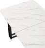 A close-up, angled view of a white marble-patterned dining table with black metal legs, set against a white background. Anteprima dell’immagine prodotto