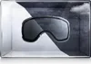 Ski goggles displayed in a box with contrasting light and dark backgrounds, suggesting different weather conditions. Produktbild-Vorschau