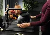 A person is washing dishes in a modern kitchen. Produktbild-Vorschau