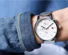 A person wearing a denim jacket and a Tommy Hilfiger watch. Produktbild-Vorschau