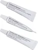 Three white tubes of grease are arranged diagonally on a white background. Produktbild-Vorschau