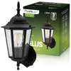 A black outdoor wall lamp is shown in front of its packaging. The packaging displays product information and branding. Anteprima dell’immagine prodotto