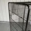A close-up view of a black metal bird cage. Náhled obrázku produktu