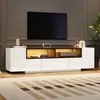 A modern living room with a TV mounted on the wall above a sleek, white TV stand with LED lighting. Produktbild-Vorschau