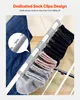 A close-up view of a drying rack with socks clipped to it, and a pair of blue jeans hanging on the side. The image highlights the sock clips. Anteprima dell’immagine prodotto