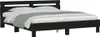 A black bed frame with a headboard and mattress, covered with white and gray bedding, is shown against a white background. Anteprima dell’immagine prodotto