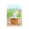 A product package for a bunny tea infuser, showing the product in use in a cup of tea. Náhled obrázku produktu