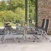 An outdoor patio setting with a table and chairs. Produktbild-Vorschau