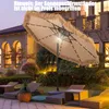 A patio umbrella with lights and fringe is set up in a backyard at dusk, with lounge chairs and a house in the background. Podgląd zdjęcia produktu