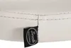 A close-up of a white leather-like material with stitching and a black brand tag. Podgląd zdjęcia produktu