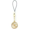 A gold-colored charm with the Guess logo and clear stones, attached to a black string, against a white background. Podgląd zdjęcia produktu