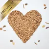 A heart shape made of birdseed and mealworms on a white background, with a premium ribbon overlay. Produktbild-Vorschau
