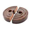 Two halves of a brown ceramic fermentation weight for a sauerkraut crock. Podgląd zdjęcia produktu
