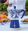 A decorated coffee maker on a table with pastries and fruit. Anteprima dell’immagine prodotto