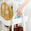 A hand is shown holding the handle of a white rolling cart filled with various bottles of cleaning or personal care products. Náhled obrázku produktu