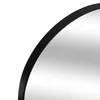 A close-up view of the edge of a round mirror with a black metal frame. Anteprima dell’immagine prodotto