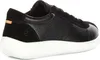 A close-up side view of a black Ecco sneaker with a white sole. Náhled obrázku produktu