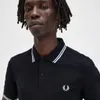 A close-up shot of a man wearing a black polo shirt. Produktbild-Vorschau