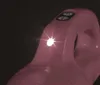 A close-up shot of the top part of a pink handheld vacuum cleaner, focusing on the power buttons and a bright LED light. Podgląd zdjęcia produktu