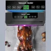 A vacuum sealer machine is shown sealing a whole roasted duck in a plastic bag. The machine has a digital display and buttons for different settings. Náhľad obrázku produktu