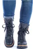 A pair of black lace-up boots worn with blue jeans. Anteprima dell’immagine prodotto