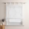 A white sheer curtain with a wavy embroidered pattern hangs on a window. Produktbild-Vorschau