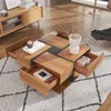 A modern living room setting with a coffee table on a rug. Produktbild-Vorschau