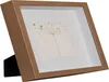 A framed artwork with a botanical illustration is displayed on a stand. Náhľad obrázku produktu