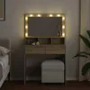 A vanity table with LED lights and a stool in a bedroom setting. Náhled obrázku produktu