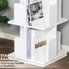 A white rotating bookshelf with books on its shelves, placed indoors. Podgląd zdjęcia produktu