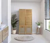 A bathroom with a wooden cabinet, plants, and a rug. Náhľad obrázku produktu