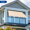 A beige awning is installed on a balcony of a modern house. Náhľad obrázku produktu