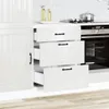 A white kitchen cabinet with three drawers, one of which is open, and a built-in oven next to it. Náhled obrázku produktu