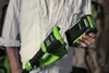 A person is holding a Greenworks lawn trimmer and a battery. Náhled obrázku produktu