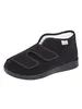 A single black slipper with velcro straps is shown against a white background. Produktbild-Vorschau
