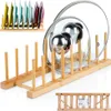 A bamboo dish and lid rack displaying various colored plates and pot lids. Produktbild-Vorschau