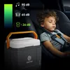A young boy sleeping in a car seat next to a portable cooler. Náhľad obrázku produktu