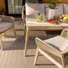 An outdoor dining set with chairs and a table on a patio. Náhľad obrázku produktu