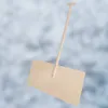 A wooden snow shovel with a handle against a blurred snowy background. Náhled obrázku produktu