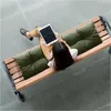 A woman sits on a bench with cushions, using a tablet. Náhled obrázku produktu