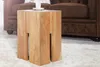 A wooden side table with a cup and saucer on top, placed on a fluffy rug next to a brown sofa. Produktbild-Vorschau