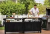 A man is preparing food at an outdoor kitchen island next to a grill. Náhled obrázku produktu