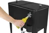 A person is opening a bottle of soda using the built-in bottle opener on a black cooler. Produktbild-Vorschau