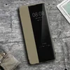 A smartphone with a flip case on a wooden surface, next to a folded map and a piece of fabric. Produktbild-Vorschau