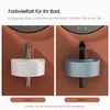Two different models of compact wall-mounted sinks are displayed against a brown textured wall. Anteprima dell’immagine prodotto